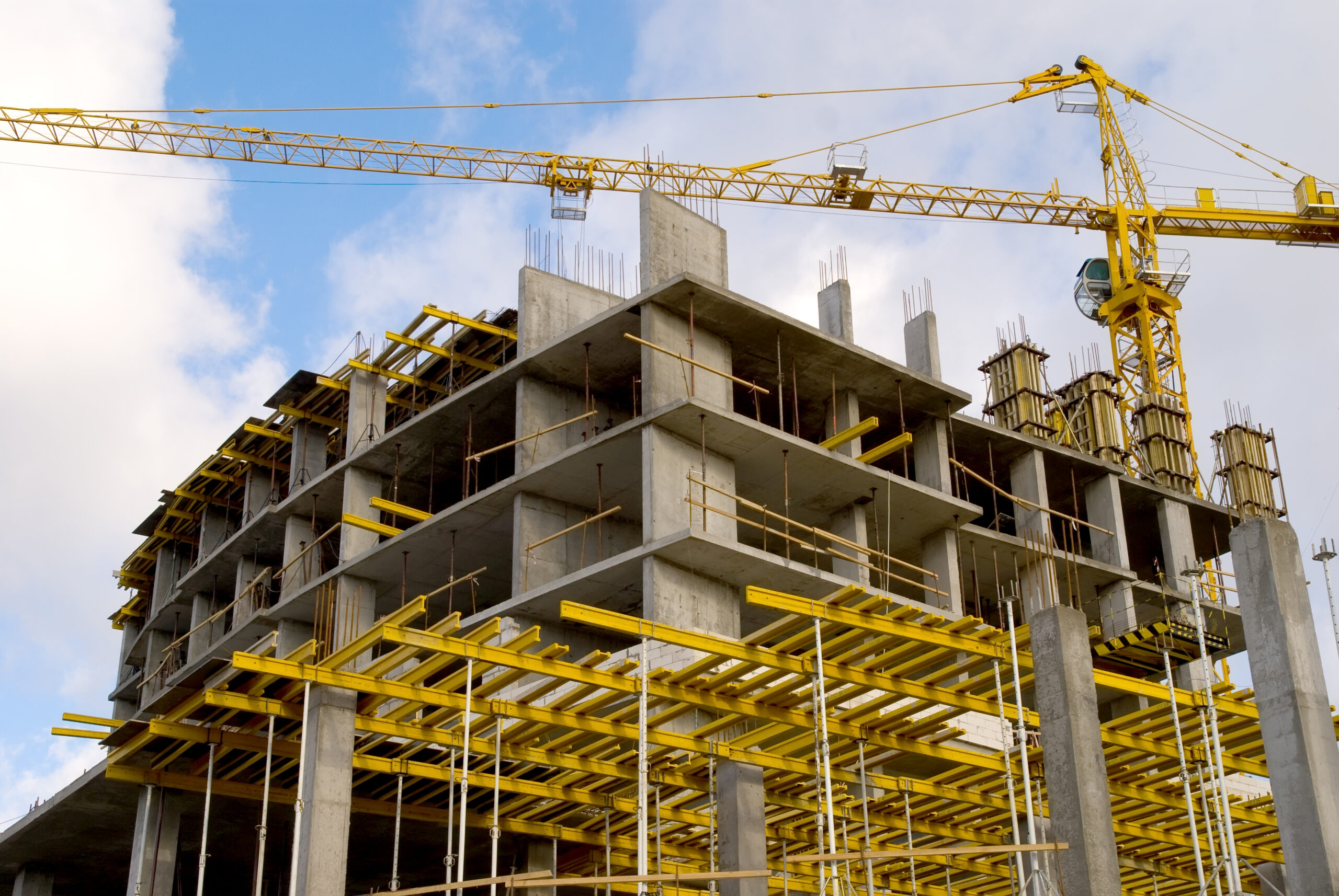 crane near building on cloudly sky horizontal